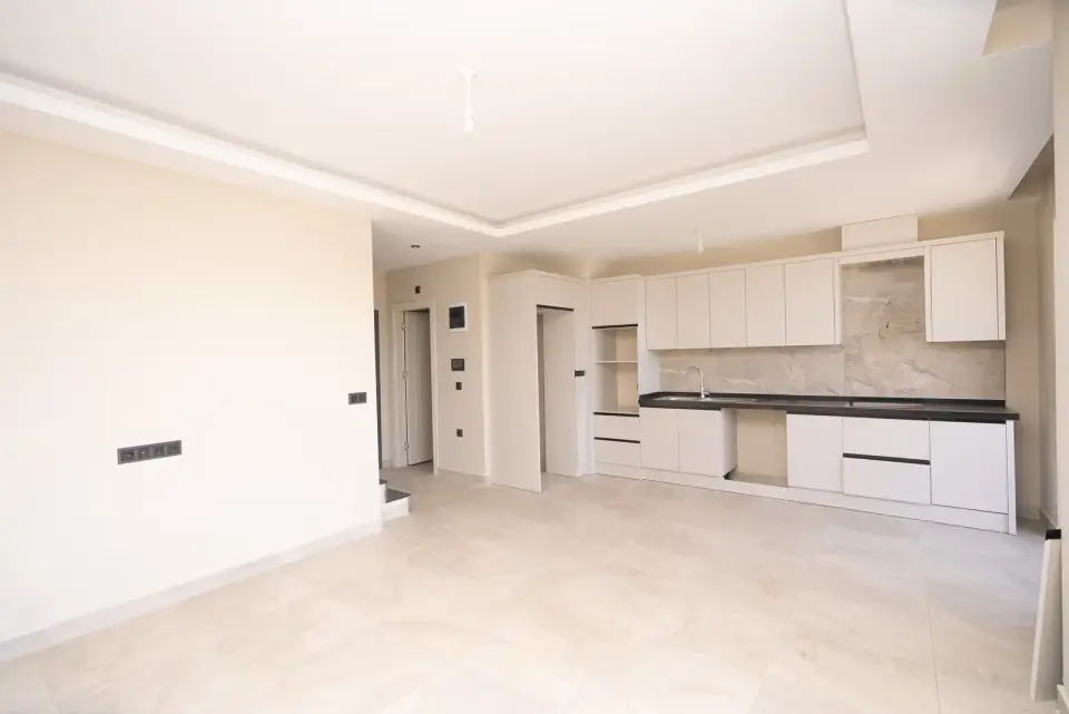 A spacious kitchen and living room in a 2+1 apartment