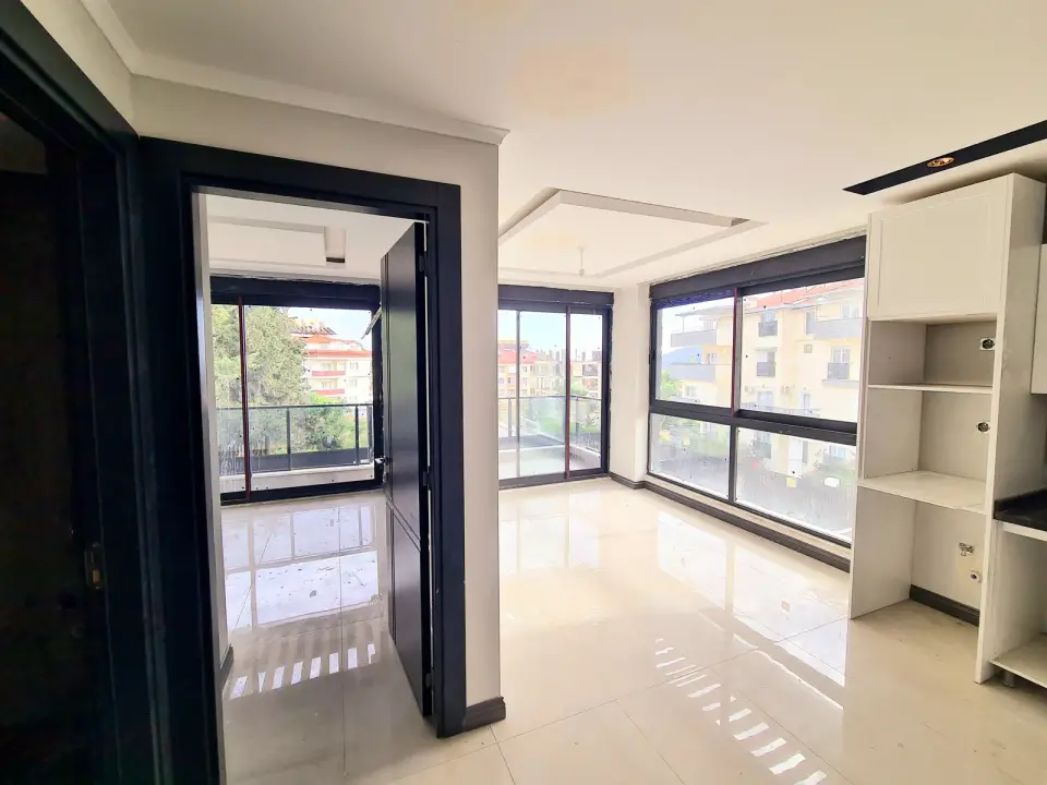 Living room with large windows in a finished apartment